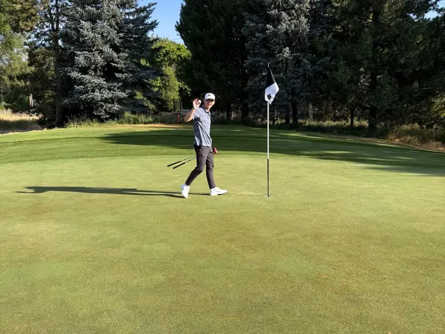 A golfer hitting a shot from the fairway at Riverside Country Club, with the mountains ahead.