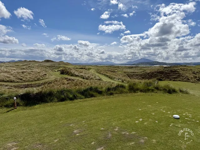A fairway on the Sandy Hills lined with dunes, running toward the bay.