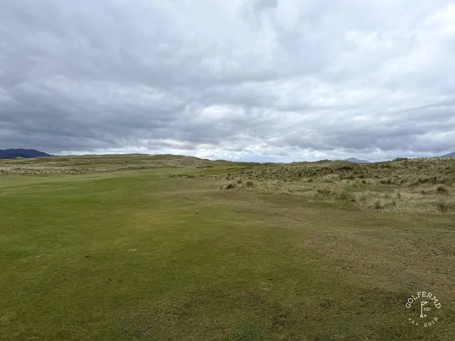 A fairway on St. Patrick's lined with dunes, running toward the bay.
