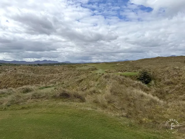 A wide fairway on St. Patrick's, with the dunes and the mountains in the distance.