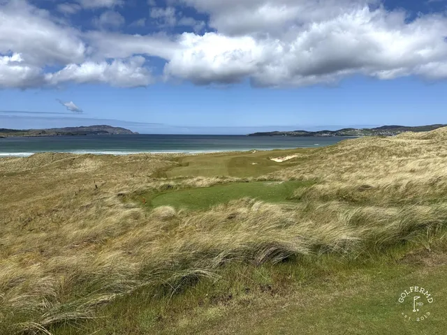 A fairway on St. Patrick's with a bunker along one side and the water ahead.