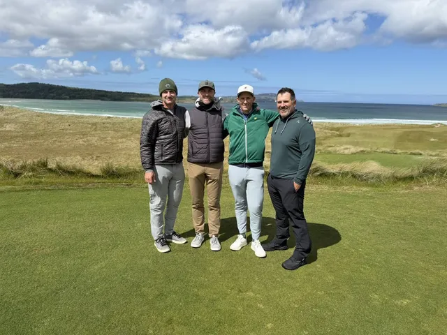 A wide view across St. Patrick's, with fairway, dunes, and the ocean.