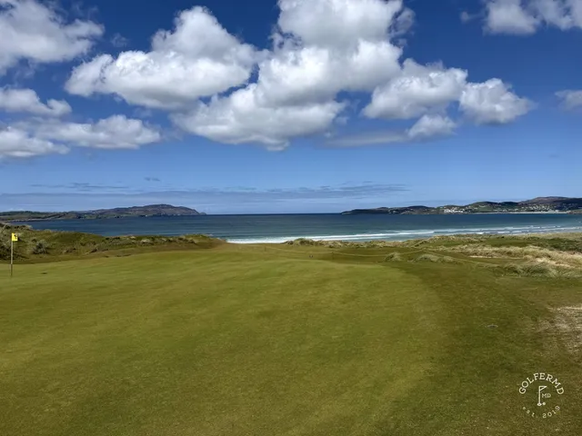 A close view of a flagstick on St. Patrick's, framed by the dunes.