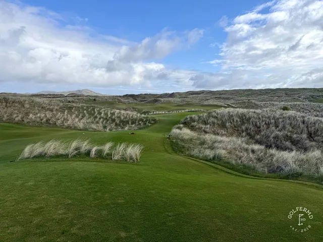 A green and flagstick on St. Patrick's, with a large bunker guarding the front.