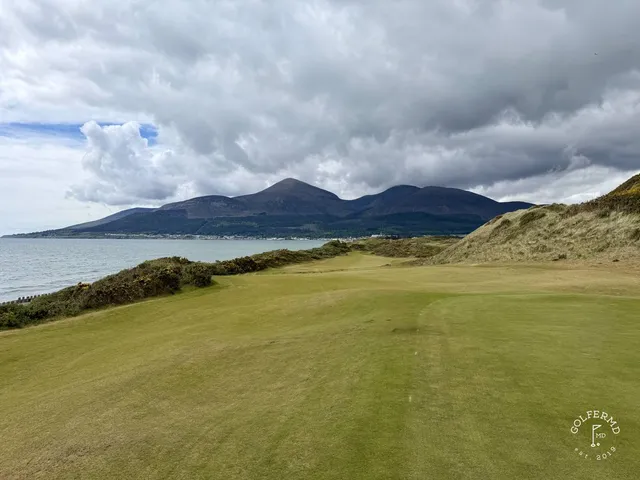 A tee shot on the Annesley Links, the fairway dropping toward a green in the dunes.