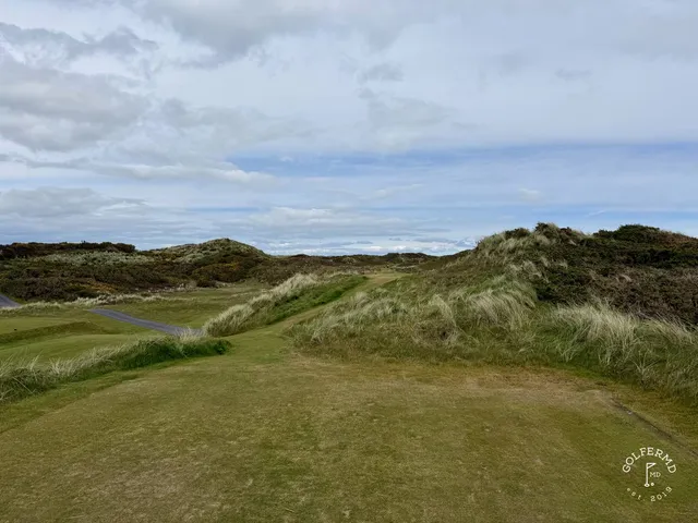 A tee at Royal County Down looking down a fairway lined with gorse.