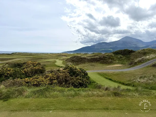 A fairway at Royal County Down with a bunker on the right and the bay ahead.