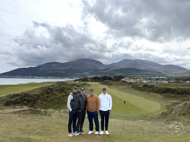 A green and flagstick at Royal County Down, a deep bunker short of the hole and the dunes behind.