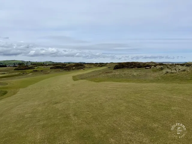 A fairway at Royal County Down running along the dunes, with the green in the distance.