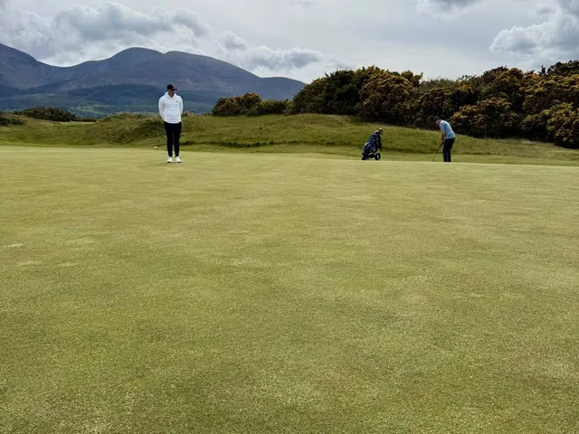 A wide hole at Royal County Down, the fairway set between gorse and the mountains.