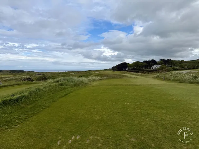 A tee at Royal Portrush looking down a fairway lined with dunes.