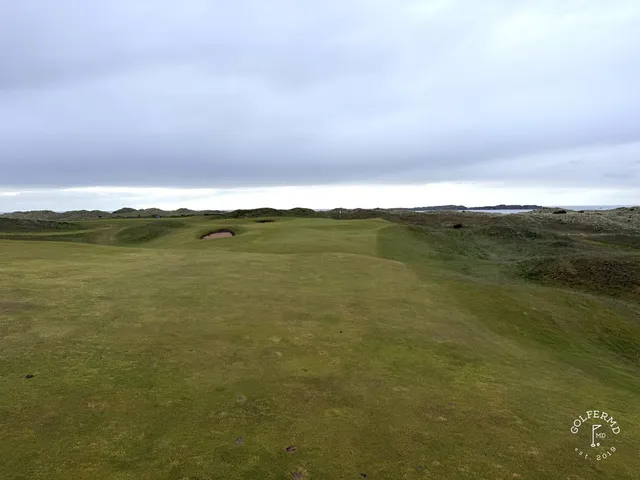 An elevated view across Royal Portrush, fairways and bunkers in front of the Atlantic.