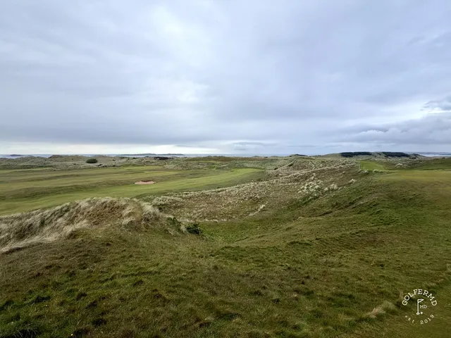 A fairway at Royal Portrush running along the dunes, with the green in the distance.