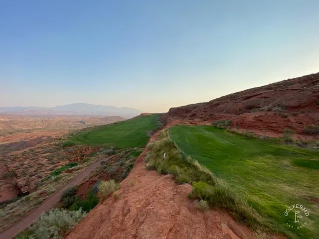 An elevated view of a hole at Sand Hollow, the fairway winding toward the red rock.