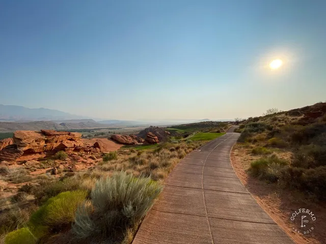 A fairway at Sand Hollow running along the red rock, with a bunker short of the green.