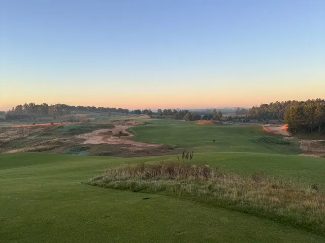 A green at Sand Valley seen from the fairway, with bunkers around the hole.
