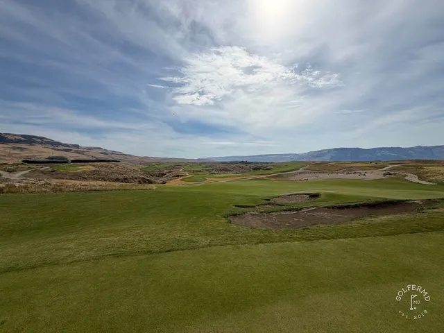 A wide view of Scarecrow, sandy ground and a small green in the distance.