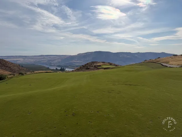 A close flagstick at Scarecrow, marram grass and sand around the green.
