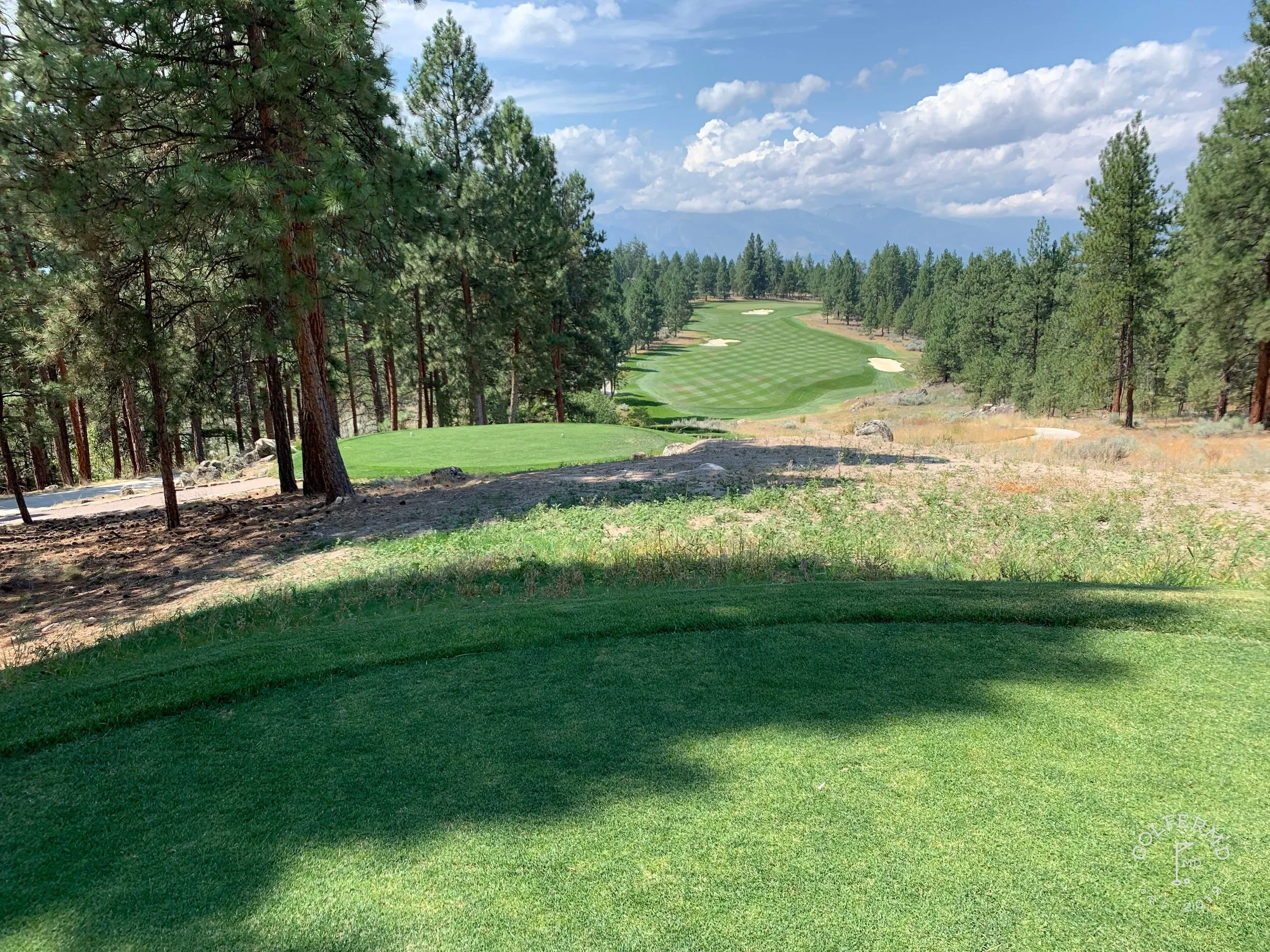 A pot bunker in the foreground and a long view down the coast to the green.