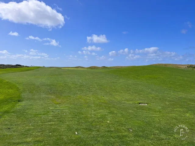 A fairway running toward the ocean at The Links at Spanish Bay, with dunes on both sides.