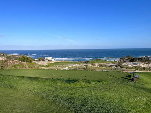 A green and flagstick beside a pond at Spyglass Hill Golf Course, with cypress trees and dunes around the hole.
