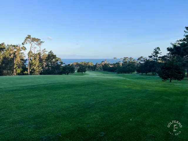A fairway through the dunes at Spyglass Hill Golf Course, with the ocean on the horizon.