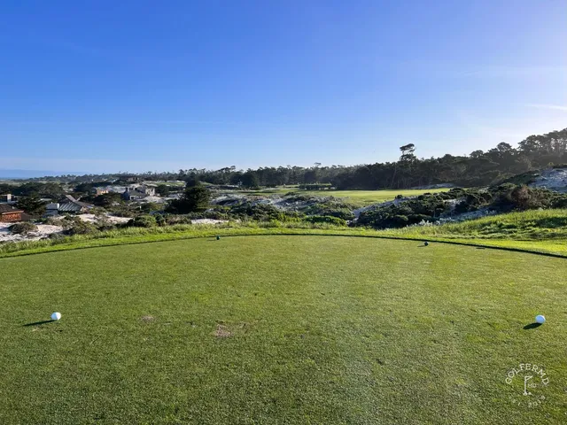 A fairway and green in the dunes at Spyglass Hill Golf Course, with the ocean beyond.