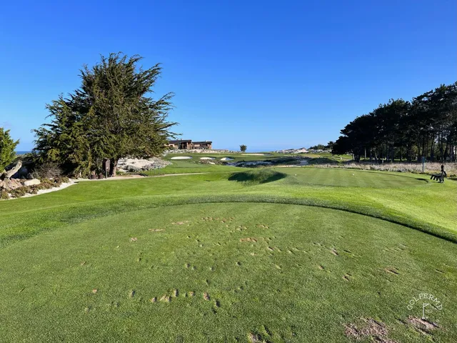 A narrow fairway between the dunes at Spyglass Hill Golf Course, with the ocean ahead.