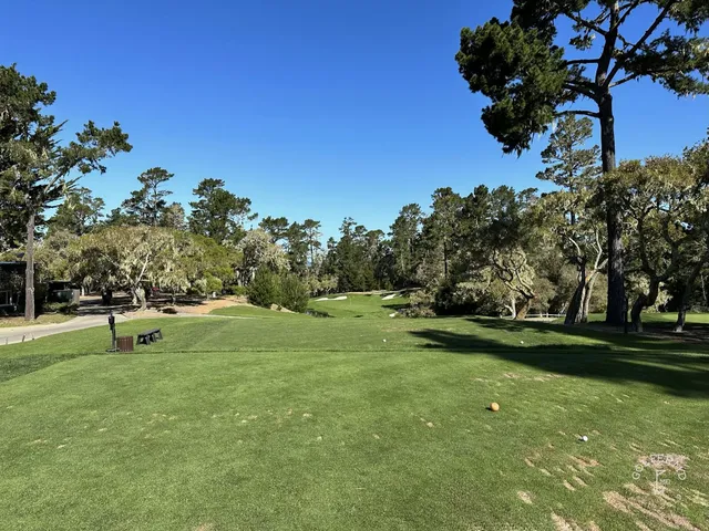 A green and flagstick above the ocean at Spyglass Hill Golf Course.
