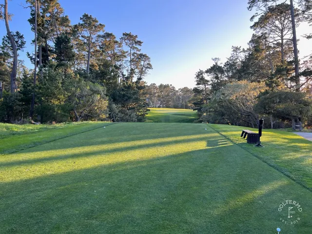 A green and flagstick in the dunes at Spyglass Hill Golf Course, with the ocean beyond.