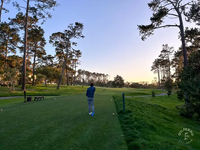 A fairway and green in the dunes at Spyglass Hill Golf Course, with the ocean beyond.