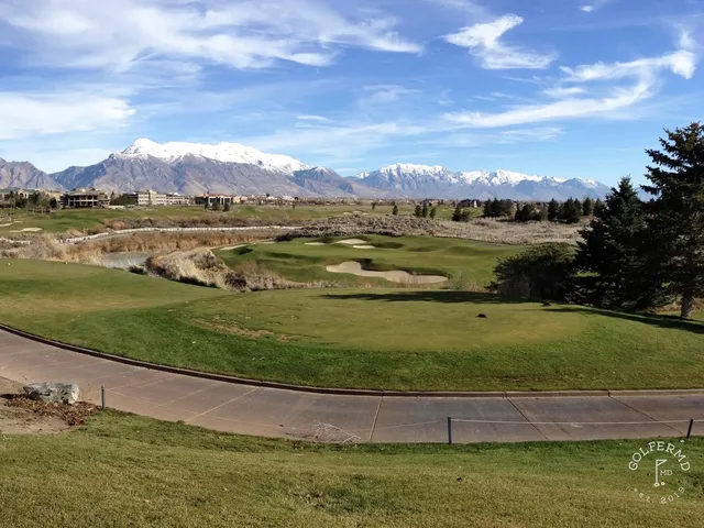 A fairway at Thanksgiving Point running toward the mountains, with trees along the hole.