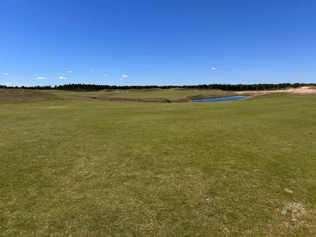 A wide view at The Lido, the fairway set in open sand.
