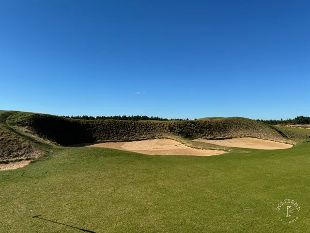 An elevated view of The Lido, several holes in the sand.