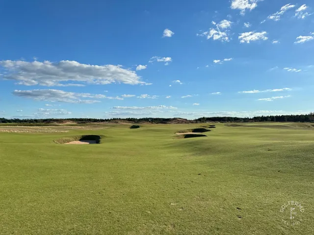 A last wide view across The Lido, with the bunkers and the sandy ground.