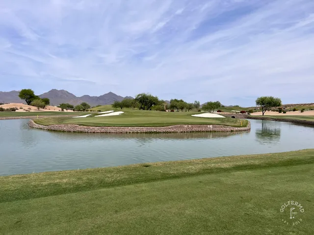 A wide desert fairway at TPC Scottsdale, with the McDowell Mountains in the distance.