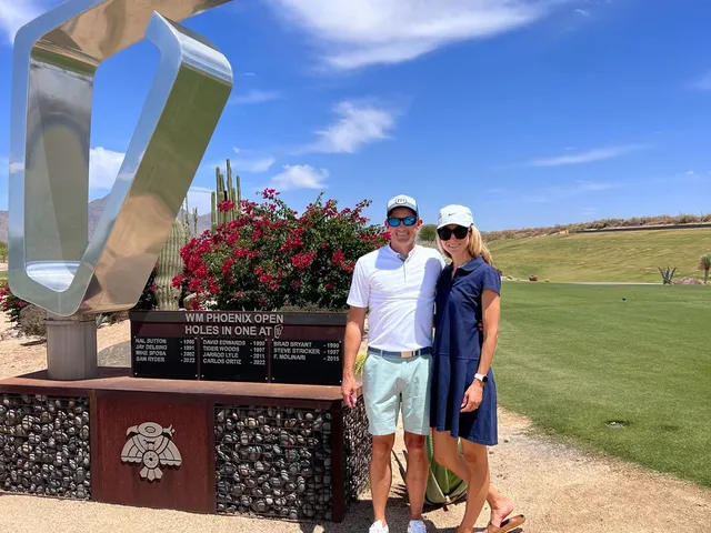 Desert ground and scattered trees at TPC Scottsdale, with the McDowell Mountains in the distance.