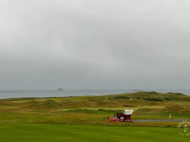 A wide view of the links at Tralee, with the fairway and the bay.