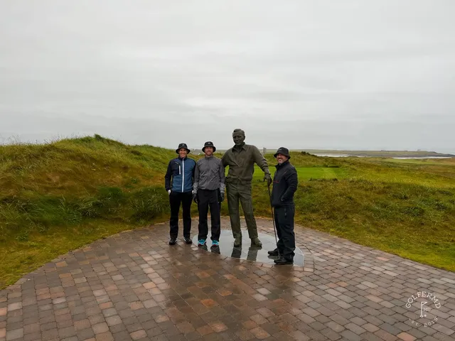 A fairway at Tralee bending through the dunes toward a distant green.