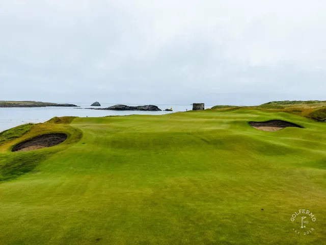 A fairway at Tralee running toward the water, with the dunes on both sides.