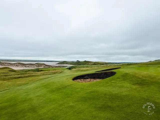 A narrow fairway at Tralee pinched by dunes, running toward the Atlantic.