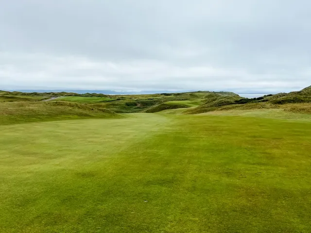 A green at Tralee with the pin toward the back and sand short of the hole.