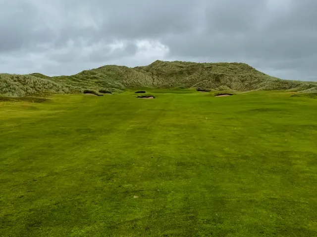 A wide view of the links at Doonbeg, with the fairway and the sea.