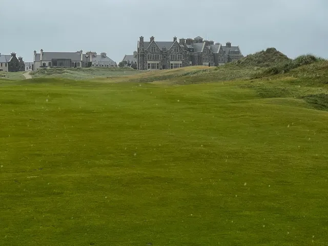A green at Doonbeg above the beach, with the flagstick and the bay beyond.