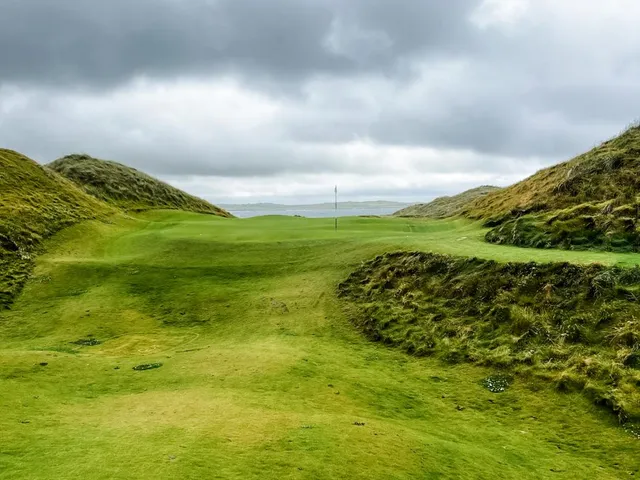 Golfers on a tee at Doonbeg, with the Atlantic behind them.