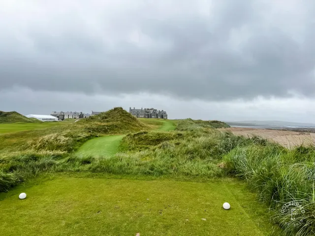 The beach and the links at Doonbeg under a bright sky.