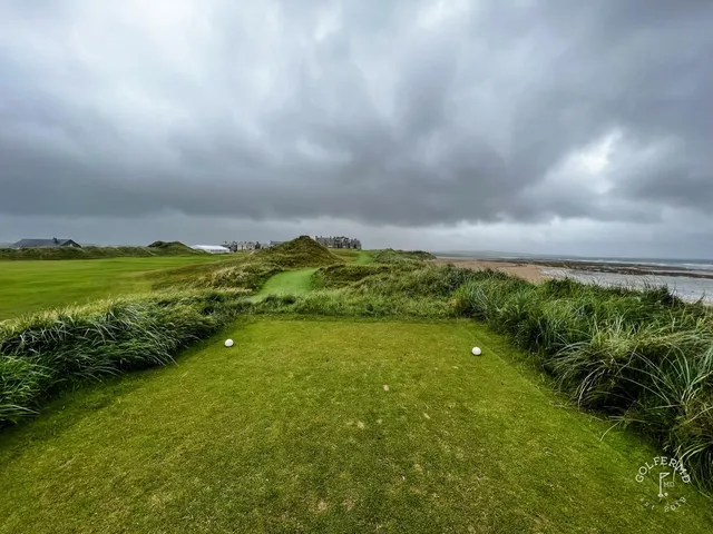 A fairway at Doonbeg running along the dunes, with the green in the distance.