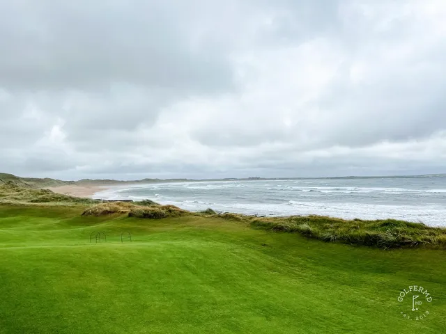 A fairway at Doonbeg from the tee, bunkers on both sides and the ocean ahead.