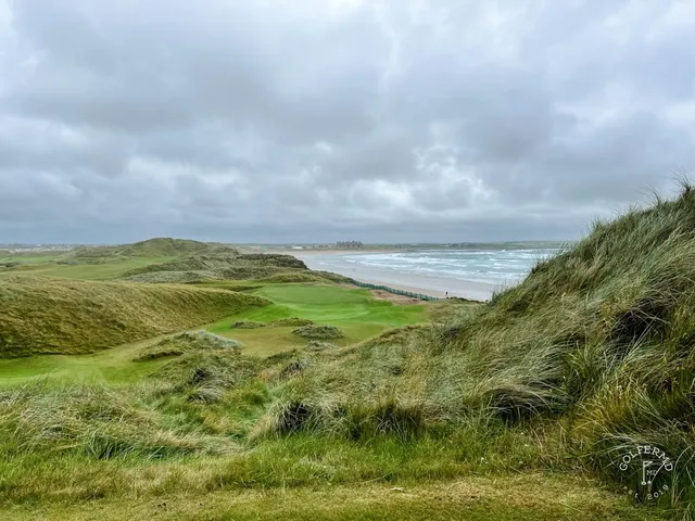 A green and bunker at Doonbeg, the flagstick against the ocean.