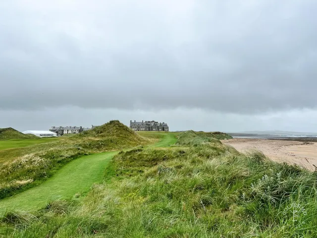 A fairway at Doonbeg running toward the water, with the dunes on both sides.